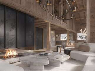 This stunning chalet boasts a spacious open-plan living area with a cozy fireplace, perfect for relaxing after a day on the slopes.