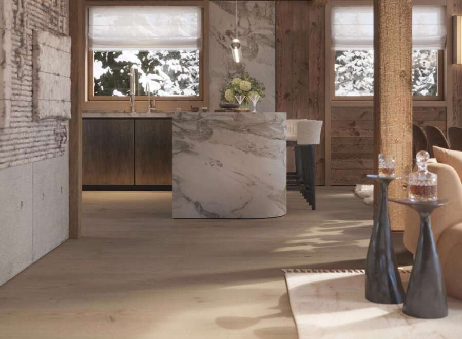 This stunning chalet boasts a luxurious open-plan kitchen with marble island, seamlessly flowing into a cozy living area.