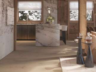This stunning chalet boasts a luxurious open-plan kitchen with marble island, seamlessly flowing into a cozy living area.