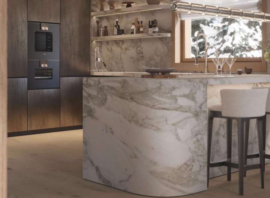 Luxury kitchen with marble island and built-in appliances.