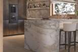 Luxury kitchen with marble island and built-in appliances.