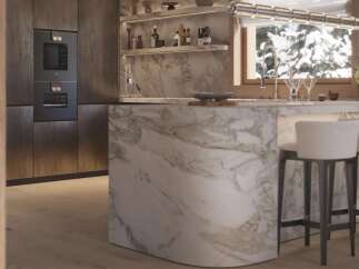 Luxury kitchen with marble island and built-in appliances.