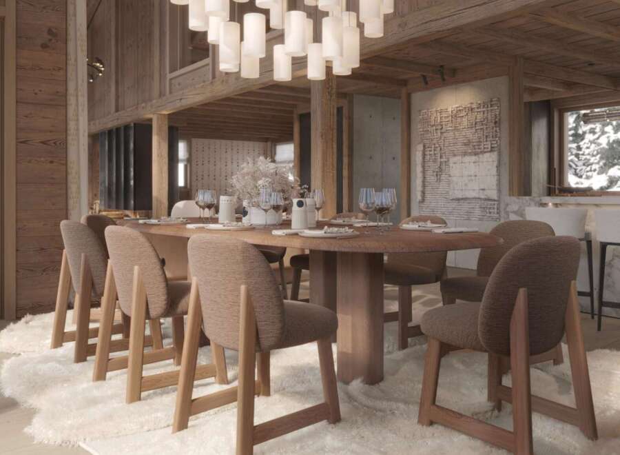 This stunning chalet boasts a spacious dining area perfect for gatherings, featuring a large wooden table surrounded by comfortable chairs.