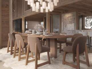 This stunning chalet boasts a spacious dining area perfect for gatherings, featuring a large wooden table surrounded by comfortable chairs.