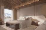 Luxurious chalet bedroom with stunning mountain views.