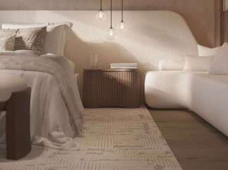 Relax in this serene bedroom, featuring a plush curved sofa and a cozy bed with soft linens.