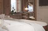 Luxurious chalet bedroom with stunning mountain views.