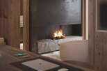 Cozy up by the fireplace in this stunning home office, featuring a unique stone hearth and modern design elements.