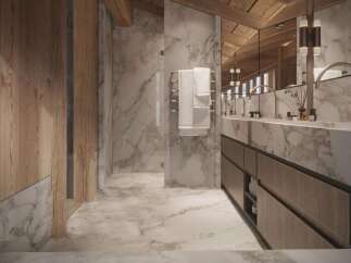 Luxurious bathroom with marble flooring and walls, wooden accents, and a double vanity.