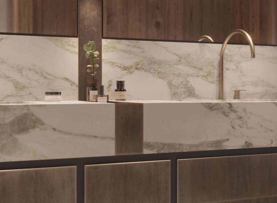 Luxury bathroom boasts a stunning marble countertop with sleek, modern faucets.