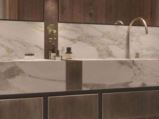 Luxury bathroom boasts a stunning marble countertop with sleek, modern faucets.
