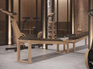 Luxury home gym with custom wooden equipment.