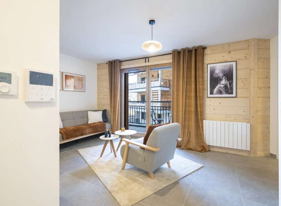 This cozy living space features a modern design with wooden accents and a neutral color palette.
