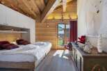 Experience the charm of this cozy bedroom with its rustic wooden accents and inviting ambiance.