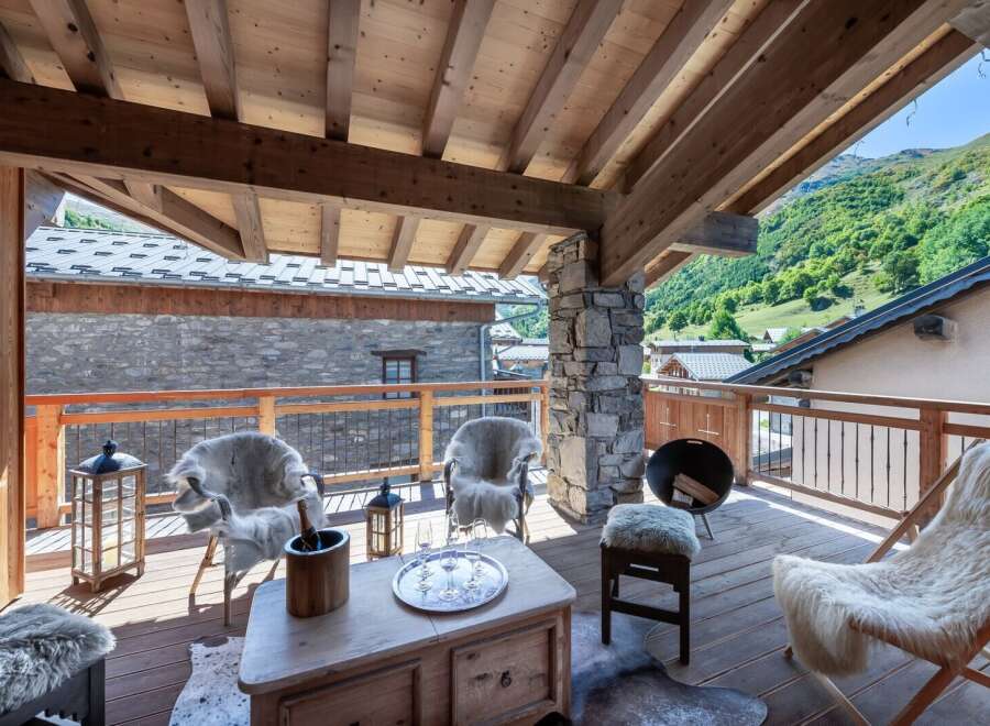 Enjoy breathtaking mountain views from this stunning chalet balcony.