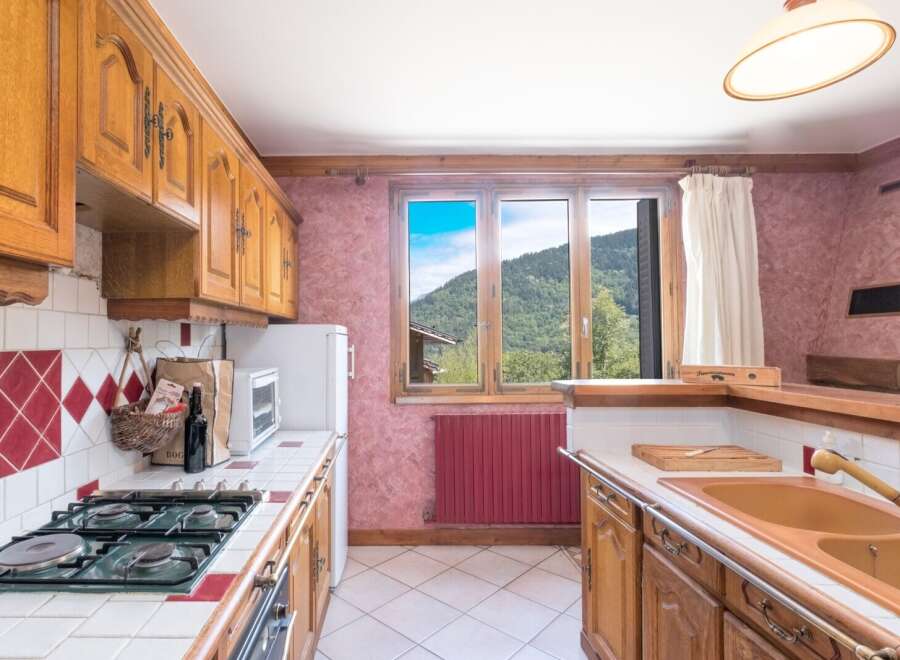 This charming kitchen boasts classic wooden cabinetry and a cozy atmosphere.