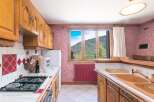 This charming kitchen boasts classic wooden cabinetry and a cozy atmosphere.