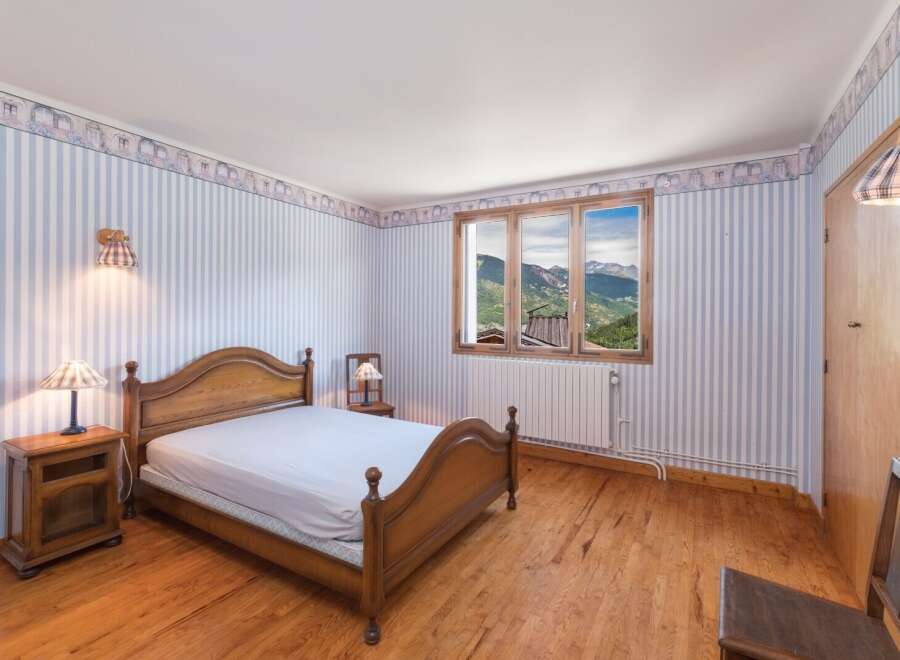 Cozy bedroom with a stunning mountain view.