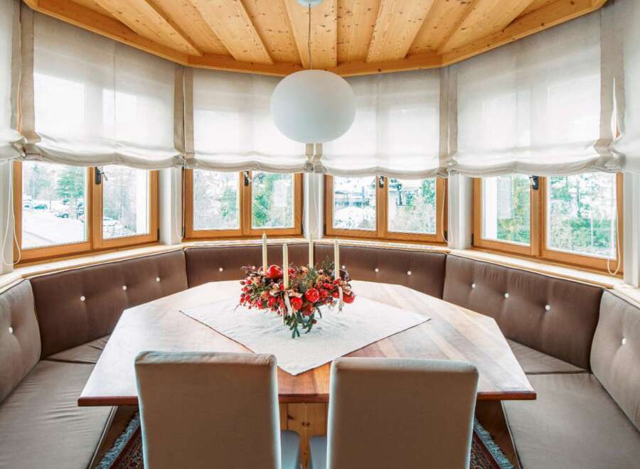Cozy mountain retreat with a stunning bay window offering breathtaking views.