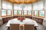 Cozy mountain retreat with a stunning bay window offering breathtaking views.
