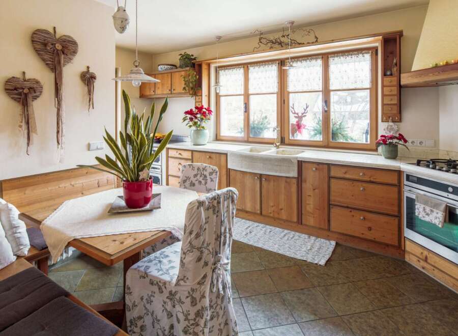 Rustic kitchen with wooden cabinets and a farmhouse sink.