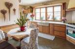 Rustic kitchen with wooden cabinets and a farmhouse sink.