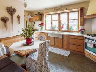 Rustic kitchen with wooden cabinets and a farmhouse sink.