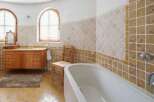 This luxurious bathroom boasts a stunning design with beige and brown tiles, creating a warm and inviting atmosphere.