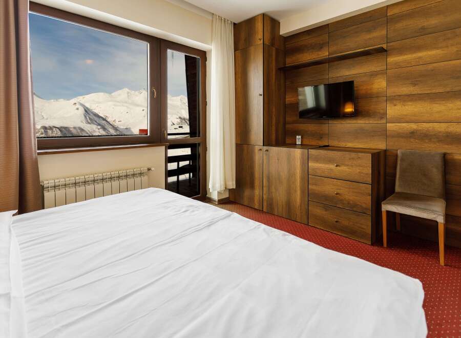 Enjoy breathtaking mountain views from this cozy hotel room.