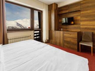 Enjoy breathtaking mountain views from this cozy hotel room.