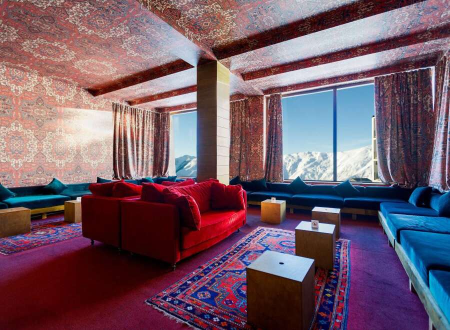 Experience luxury in this stunning property, featuring a unique design with patterned ceilings and walls.