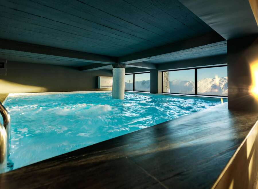 Indulge in the ultimate relaxation at this luxurious indoor pool, offering breathtaking mountain views.