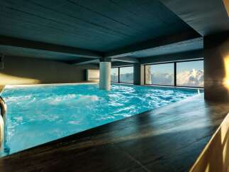 Indulge in the ultimate relaxation at this luxurious indoor pool, offering breathtaking mountain views.