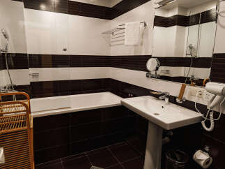 This bathroom features a modern design with a sleek white sink and toilet.