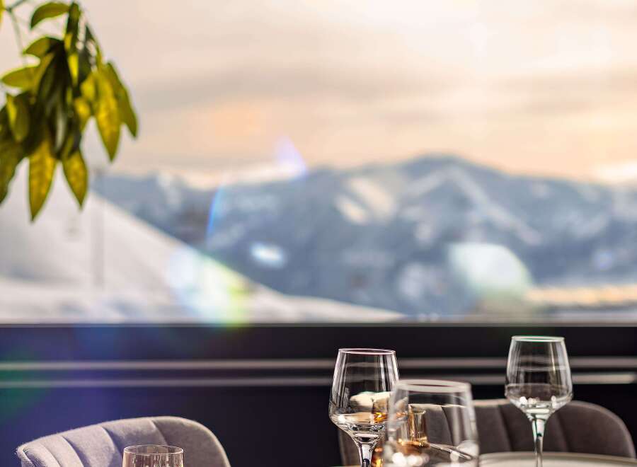 Enjoy breathtaking mountain views from this elegant dining setting.