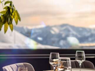 Enjoy breathtaking mountain views from this elegant dining setting.