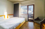 Enjoy breathtaking mountain views from this cozy hotel room.