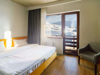 Enjoy breathtaking mountain views from this cozy hotel room.