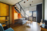 Experience modern living in this stylish apartment featuring a unique staircase design and contemporary furnishings.