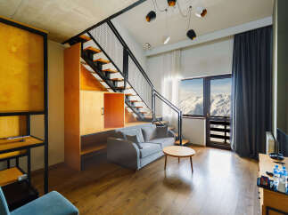 Experience modern living in this stylish apartment featuring a unique staircase design and contemporary furnishings.