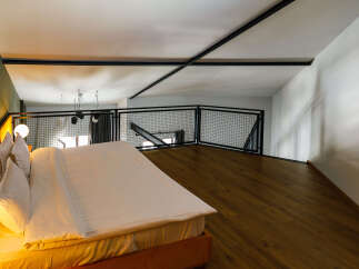 Experience modern luxury in this stylish loft bedroom.