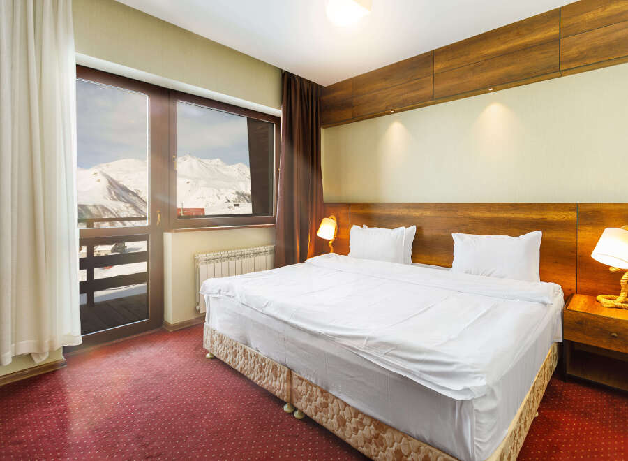 Enjoy breathtaking mountain views from this cozy hotel room.