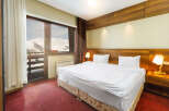 Enjoy breathtaking mountain views from this cozy hotel room.