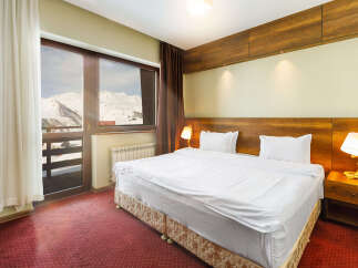 Enjoy breathtaking mountain views from this cozy hotel room.