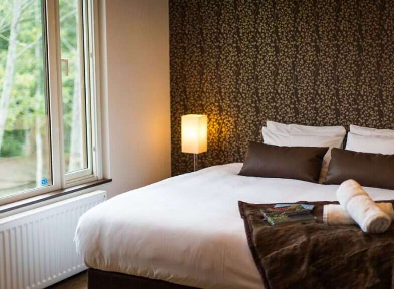 Wake up to stunning views from this cozy bedroom, featuring a comfortable double bed and luxurious linens.