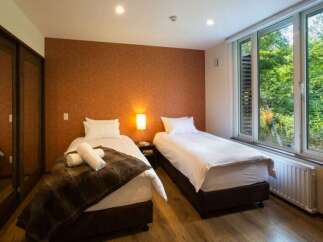 This cozy bedroom features two twin beds, perfect for a relaxing getaway.