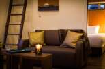 Cozy apartment featuring a comfortable couch, perfect for relaxing evenings.