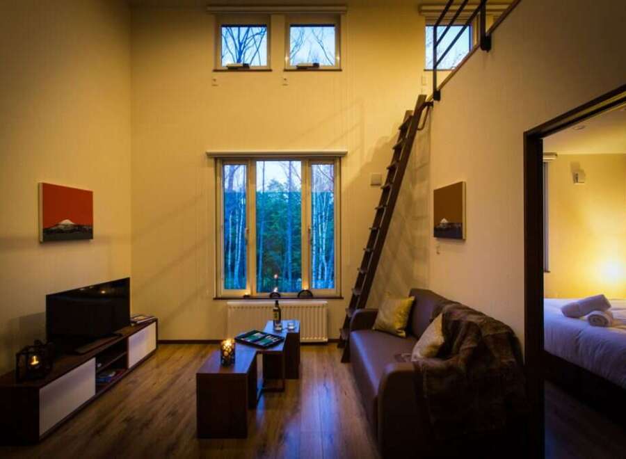 Cozy cabin with loft bedroom, perfect for a romantic getaway.