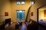 Cozy cabin with loft bedroom, perfect for a romantic getaway.