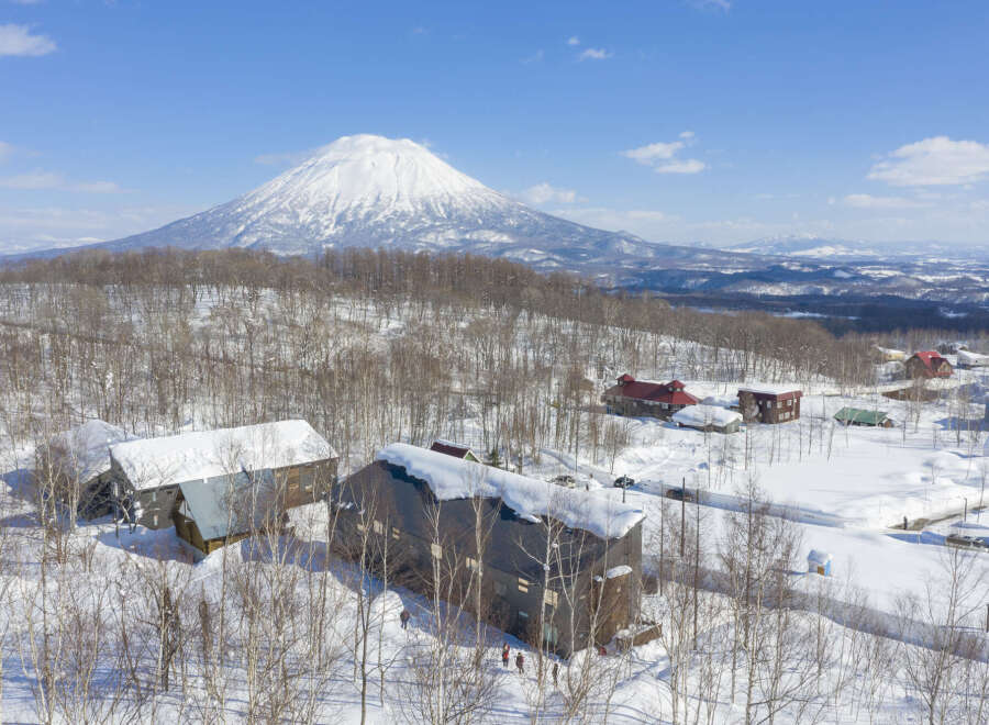 Nestled in a snowy landscape, this stunning property offers breathtaking views of a snow-capped volcano.